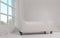 Modern White leather sofa with wheels in white room and window