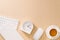 Modern white office desk with keyboard, mouse, notebook, clock and cup of coffee. Top view with copy paste. Business and strategy