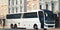 Modern white realistic coach bus at cityscape background. 3d rendering. Front view.