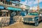 Modern Wild West scenery with tourist shops and old rusty pickup car in Oatman.