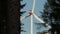 Modern wind turbine with forest blur