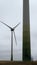 Modern windmill in broody mood. Monumental electricity wind mills in landscape. Renewable green energy.