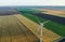 Modern windmill in field, space for text. Energy efficiency