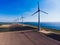 Modern windmills on rural landscape area under blue sky