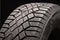 Modern winter friction tyres Velcro. safe driving. image wheel on a black background, rubber products, auto parts.