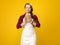 Modern woman farmer on yellow background enjoying fresh bread