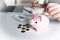 Modern woman putting Coin In pink Piggy Bank, step up growing business to success and saving for retirement concept