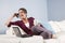 Modern woman relaxed on couch with phone, laptop