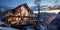 Modern wooden chalet house with snow and mountains on ski resort in cold evening.Macro.AI Generative
