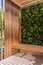 Modern wooden gazebo with vertical greening