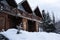 Modern wooden hotel covered with snow. Winter