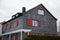 Modern wooden house with red shutters