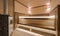 Modern wooden sauna interior with elegant lighting and electric heater