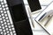 Modern workplace with laptop, silver pen, smartphone, notepad and stapler on white wooden vintage table