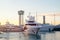 Modern yachts at sunset moored in the seaport. City landscape