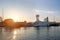 Modern yachts at sunset moored in the seaport. City landscape