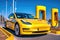 Modern yellow sports car charging on station