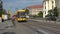 The modern yellow tram arrives at the bus stop. Dresden, Germany