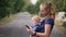 Modern young mother with a child uses a mobile phone