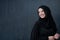 Modern young muslim woman in black abaya