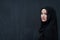 Modern young muslim woman in black abaya