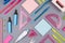 Modern youth office supply - neon blue, pink, yellow, green stationery as decorative pattern on grey desk background, top view.