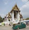 Modern yuk tuk taxi and Buddhist temple in Thailand