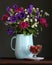 Modest bouquet of garden flowers in an enameled blue jug