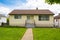 Modest family house with green lawn in front. Old residential house