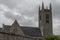 Modest gray stone and concrete church with rose window in southern Ireland one day