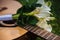 Modest white wedding bouquet lies on the guitar deck