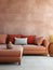 Modular corner sofa with terra cotta cushion near tiled stucco wall. Interior design of modern living room