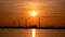 Moerdijk Netherlands, sunset winth windmills by the lake Vokerak river in Holland windmill energy sunset