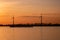 Moerdijk Netherlands, sunset winth windmills by the lake Vokerak river in Holland windmill energy sunset