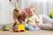 Moher and her toddler son plays with car toys in his cosy childrem room