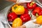 Moist bell peppers washing into bowl.