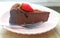 Moist and Dense Texture of Flavorful Flourless Chocolate Cake Topped with Fresh Strawberry