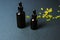 Moisturizing and healing skin serum with vitamin C on a black background. Vitamin capsules as a supplement to a cream or essence