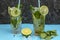 Mojito cocktail glasses with ice cubes, mint and limes and fresh limes. The best summer cocktail