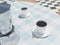 Moka coffee brewer with espresso cups, close-up shot, 3d rendering. Italian coffee culture and cuisine, retro table cloth and