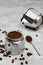 Moka pot filled with ground coffee, close-up, selective focus, gray minimalistic neutral background. Preparing Italian coffee in a