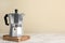 Moka pot on white marble table. Space for text