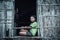 A Moken woman greets tourists on a window of a house made of natural materials at a Moken village