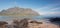 Mokolii Island [also known as Chinamans Hat] rocky beach looking toward Kualoa mountains on the North Shore of Oahu Hawaii United