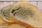Mold growing rapidly on moldy bread on wooden background. Mildew on a slice of bread. Stale bread, covered with mildew.