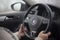 Moldova, Chisinau - 01.17.2020: CLose-up of female hands driving VW Jetta Hybrid.