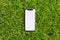 Moldova, Chisinau - 11.06.2020: Close-up of iPhone 11 with empty white mockup on outdoors background of green grass.