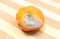 Moldy mandarin on wooden background