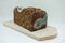 A moldy rye bread lies on a wooden board