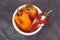 Moldy and wrinkled peppers in white bowl. Unhealthy, decompose, spoiled vegetable